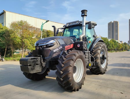 a 260HP/4WD tractor with a large tire on the side of the road