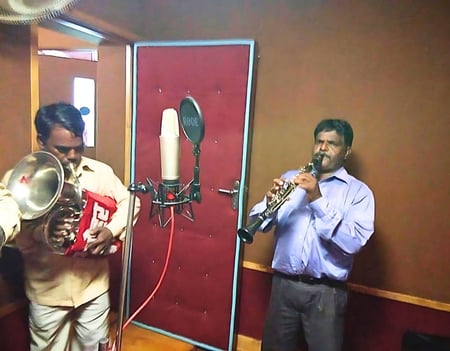 Manohar Brass Band in a music recording studio, recording their latest music.