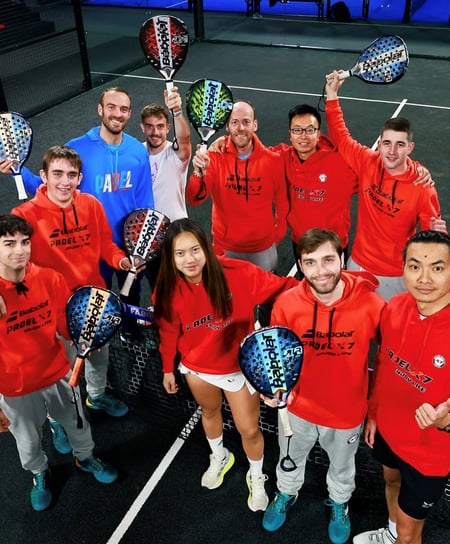 Group of padel coaches holding rackets at X7 Sabadell indoor courts