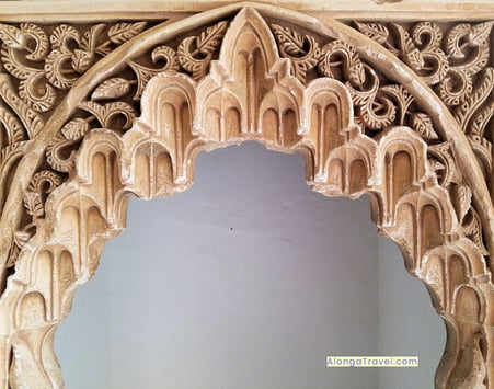 Lavish latticework on a woodwork over a door on a fine example of Mudejar architecture in Alhambra