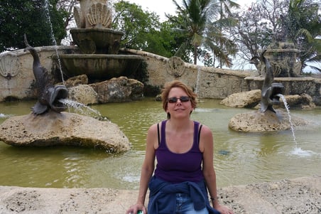 Lady rests by a fountain in La Romana, Dominican Republic