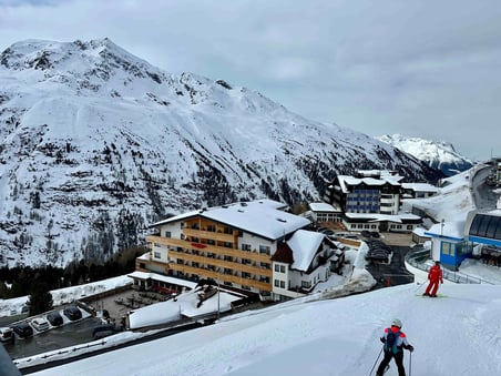 a person skiing down a snowy mountain in austria ski resort