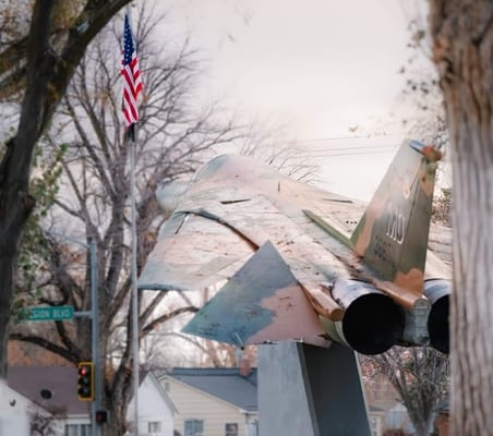 Jet display in Mountain Home Idaho with an American flag.
