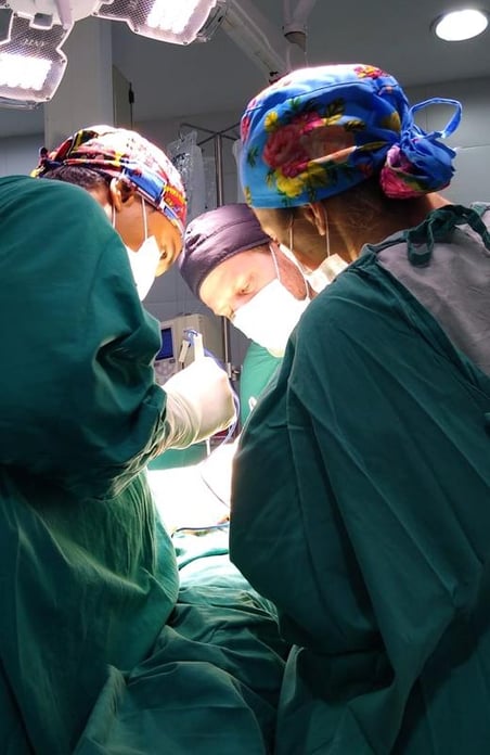 a group of surgeons performing surgery in a hospital Dra. Flavia Ward