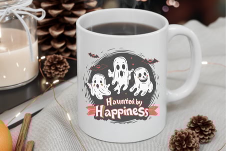 a cup of coffee with a ghost face on it