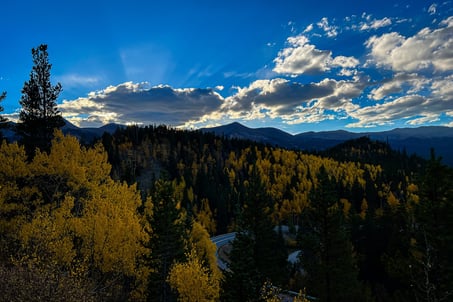 a mountain scene with a winding road and a winding road