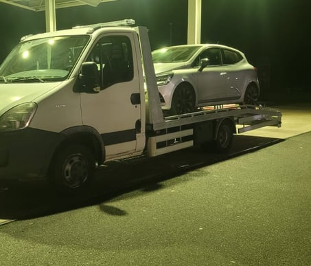 a tow truck with a flat bed and a flat bed