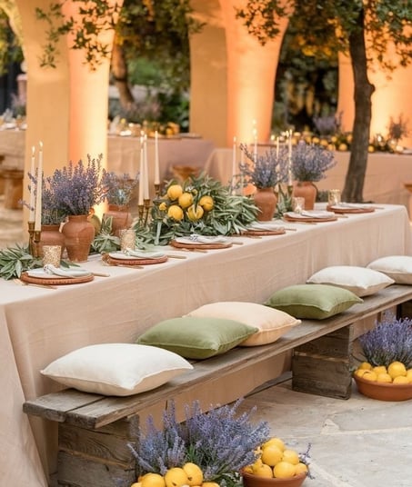 Elegant outdoor dining setup with lemons, lavender, and candles.