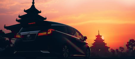 Toyota Alphard luxury van near Thai temple at sunset