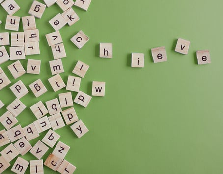 letter tiles spelling the word achieve