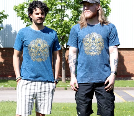 two men standing next to each other in a grassy area