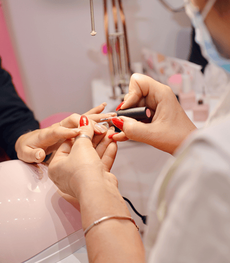 Lady applying red nail polish