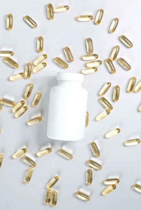 a bottle of vitamin supplements pills and capsules