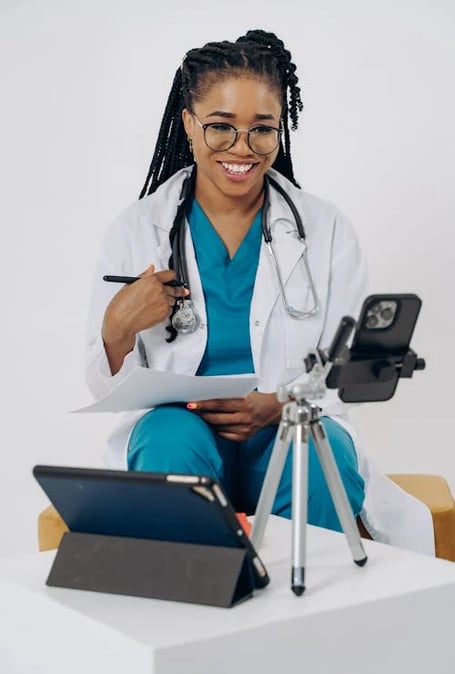 a female doctor in a white lab coat and a camera