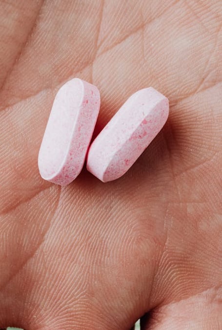 two pills on a person's hand holding a pill pill