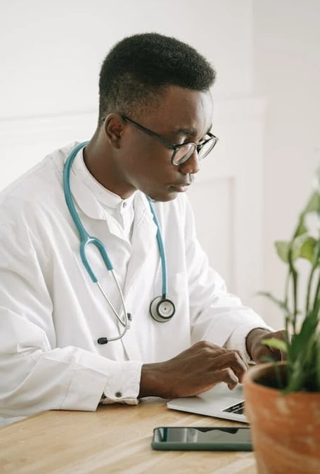 a male doctor in a white lab coat and stethrobe