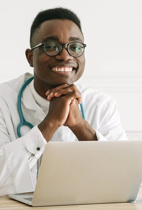 a male doctor in a white coat and glasses