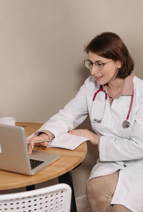 a woman in a white lab coat and a stethrobe