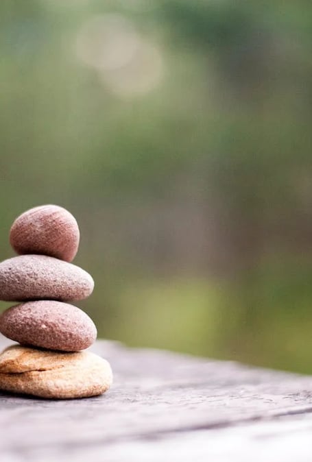 a stack of rocks sitting on top of a wooden table