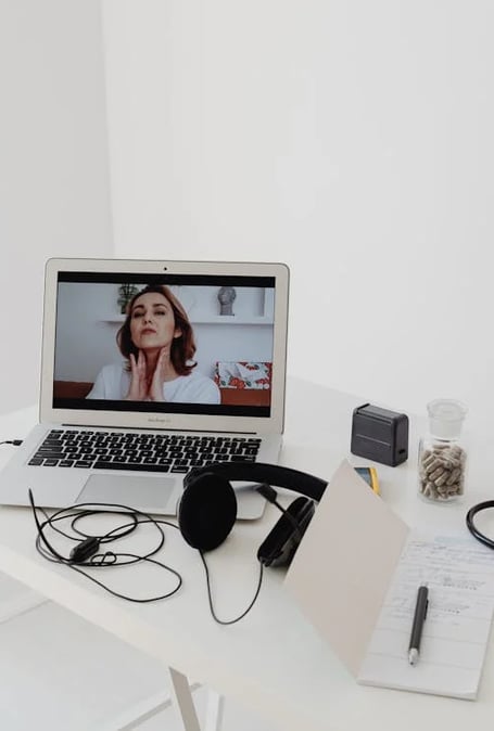 a laptop computer sitting on a table with a doctor's stethrobe