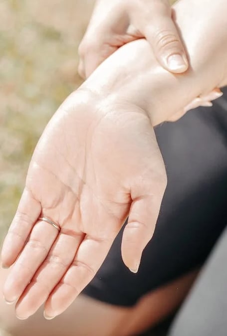 a woman holding her hand out to show off her hand