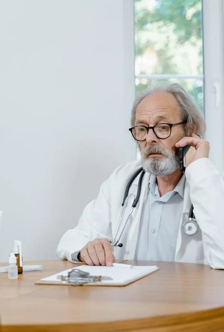 a man in a white lab coat and a stethoscope on a cell