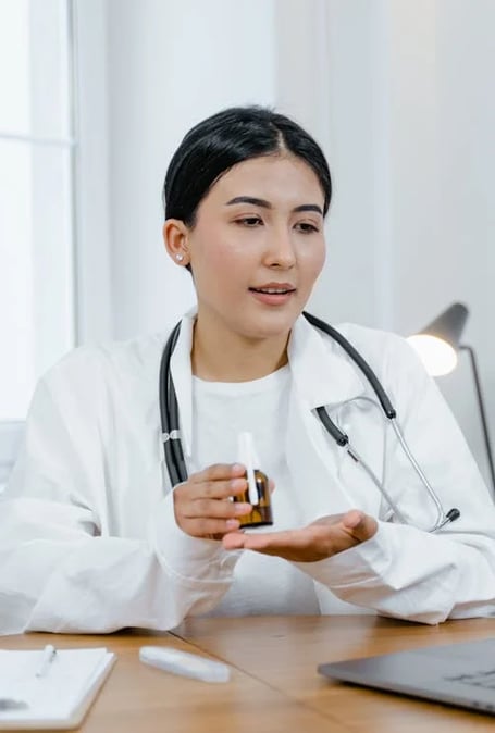 a woman doctor in a white coat and a laptop