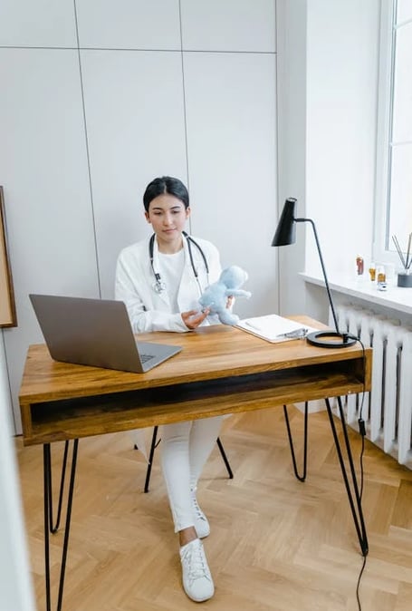 a woman in a white lab coat and a stethoscope