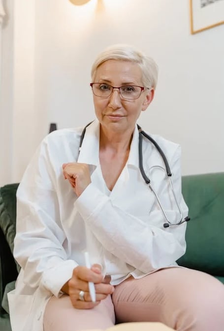 a woman doctor in a white lab coat and glasses