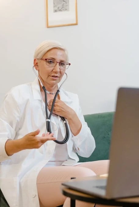 a woman in a white lab coat and a stethoscopet