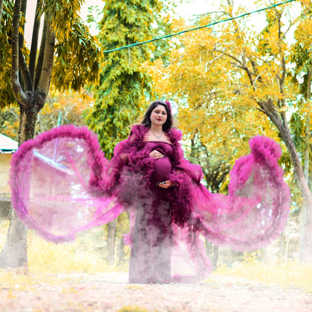 a woman in a pink dress with pink feathers