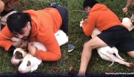 a man is laying on the ground with his dog