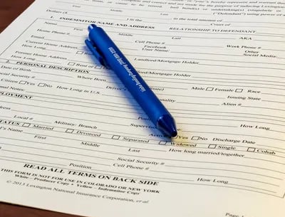 Bail bond application sitting on a table with a pen.