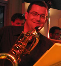 a man playing a saxophone and a saxophone