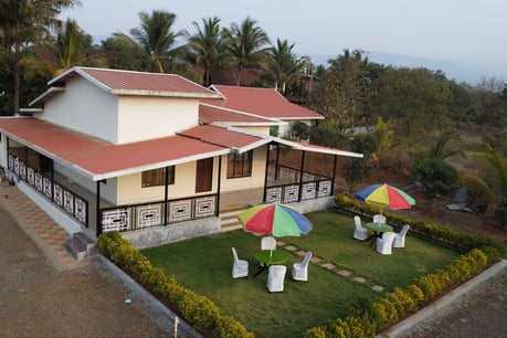 a house with umbrellas and umbrellas on a lawn