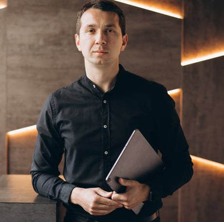 a man in a black shirt and a laptop