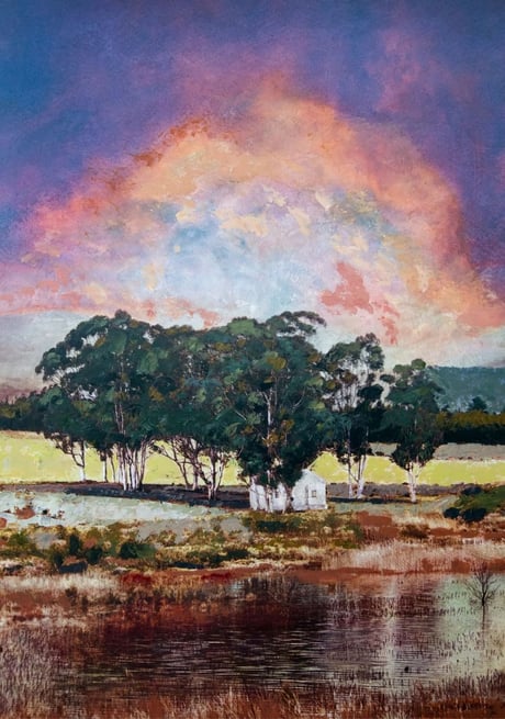 Colourful landscape painting by Martin Osner showing a white cottage surrounded by tall trees near a reflective water surface