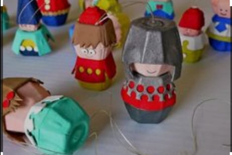 a group of paper mache dolls with a paper doll