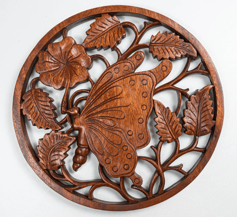 a wooden butterfly wall hanging on a wall