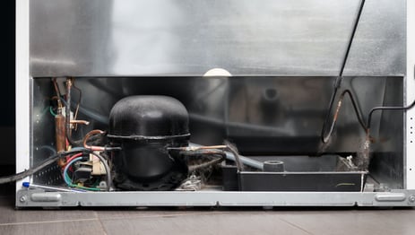 a refrigerator with a large metal container inside
