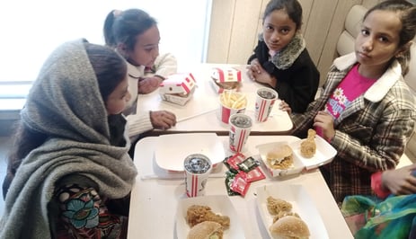 Sunday School children at Water of Life Ministries having lunch burgers and drinks