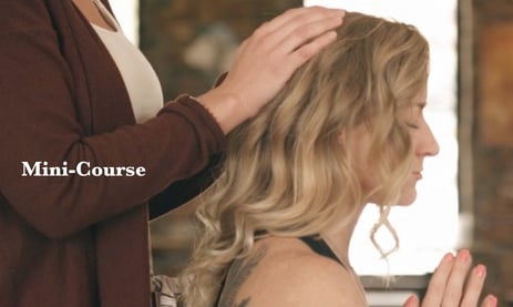 woman with hands on wowan's head