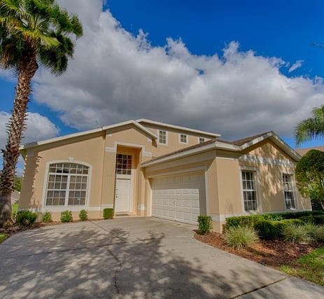 a Florida villa home with a palm tree