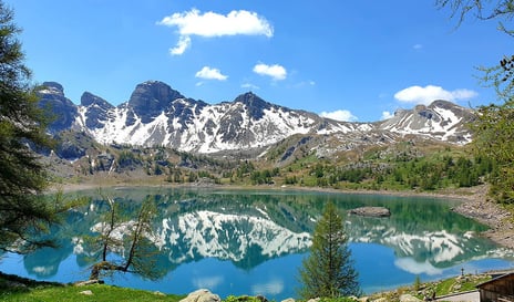 Alps mountain lake with mountains and snow