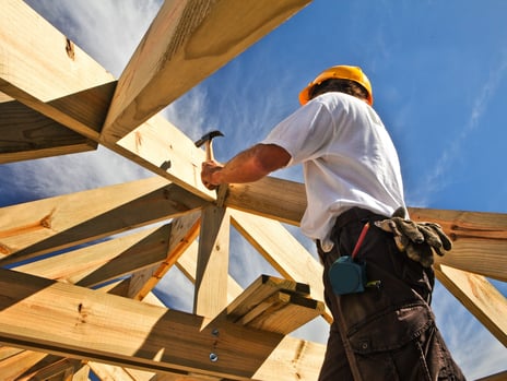 a construction worker is working on a roof; buildwithampro.com