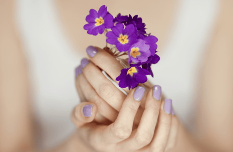 Woman's hands holding purple flowers