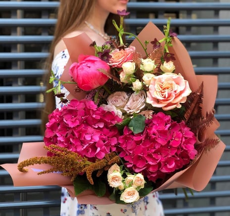 a woman holding a bouquet of flowers