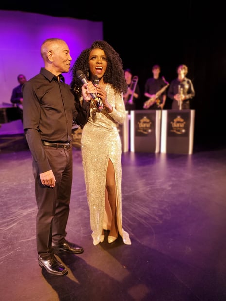 a man and woman standing on a stage