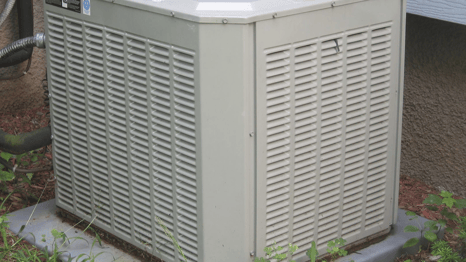 a small air conditioner sitting on a stone block