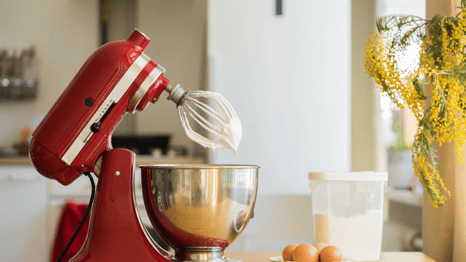 a red mixer with eggs and eggs in a kitchen